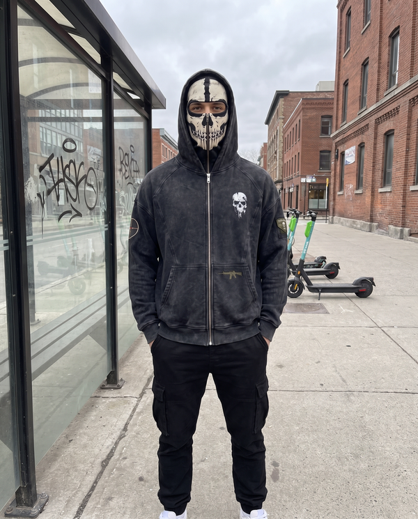 The Respawn Hoodie fully zipped with the hood up at a bus stop